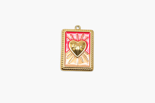 Gold-framed pendant with a heart design on a white background