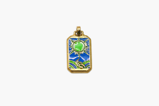 Gold pendant with green gemstone and blue background on a white background