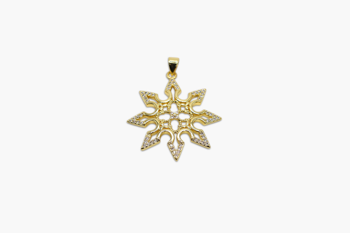 Gold snowflake pendant on a white background