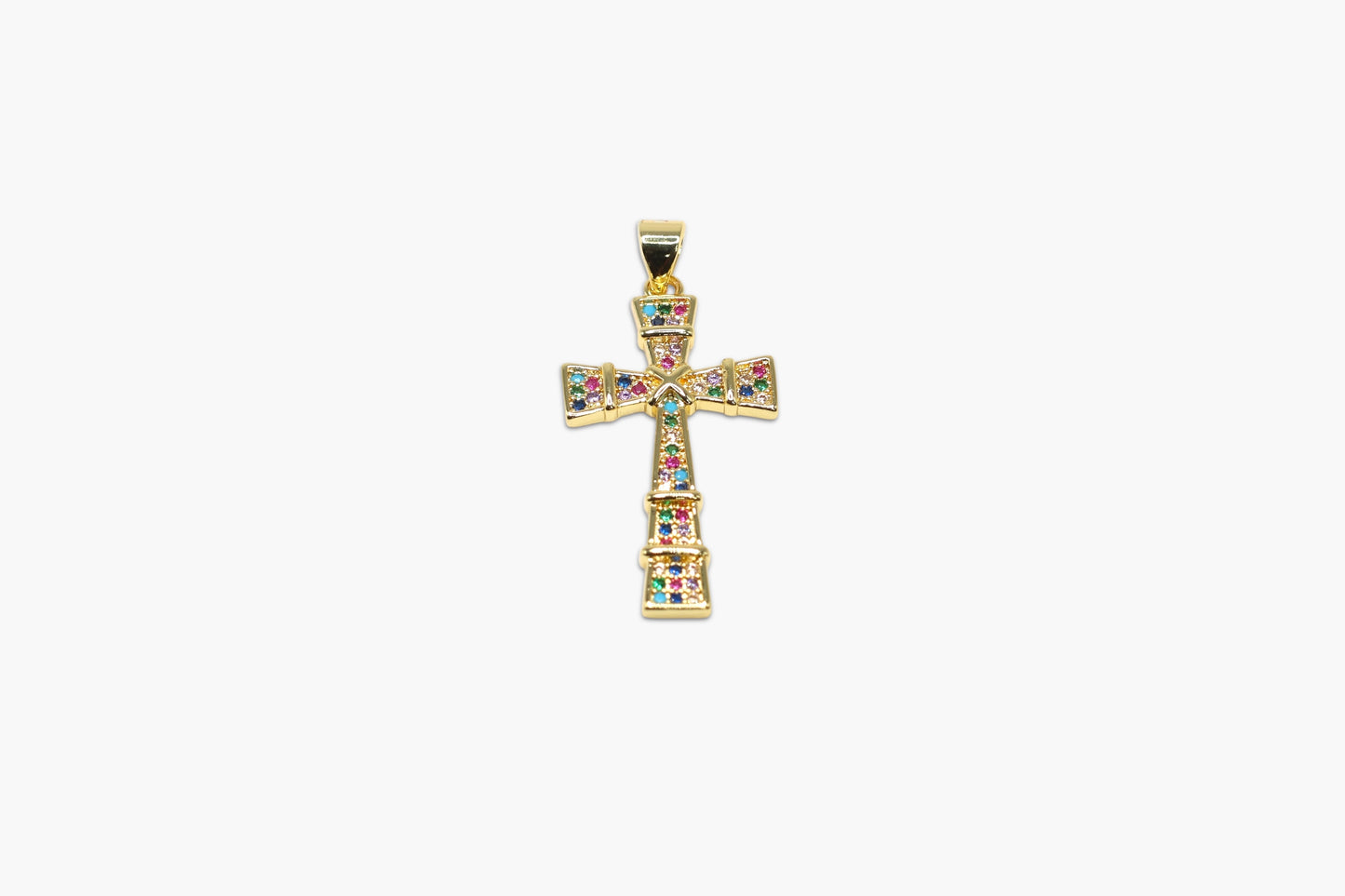 Gold cross pendant with colorful gemstones on a white background