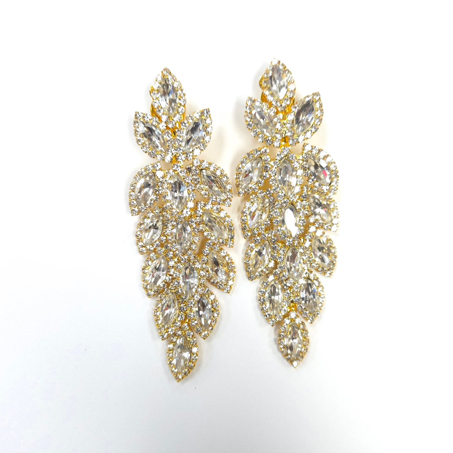 Gold and crystal earrings on a white background