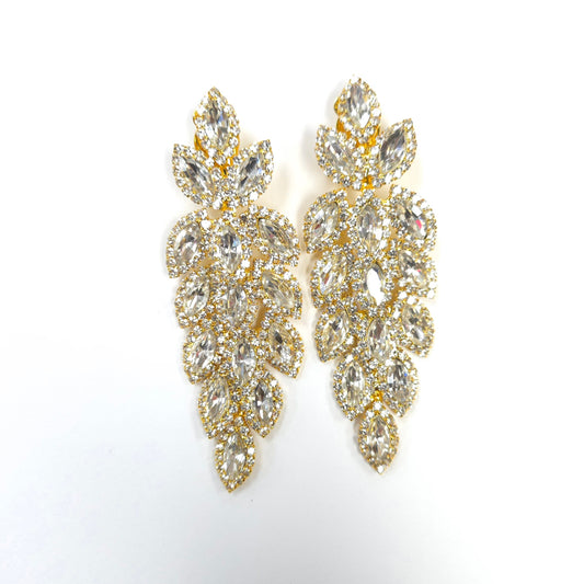 Gold and crystal earrings on a white background