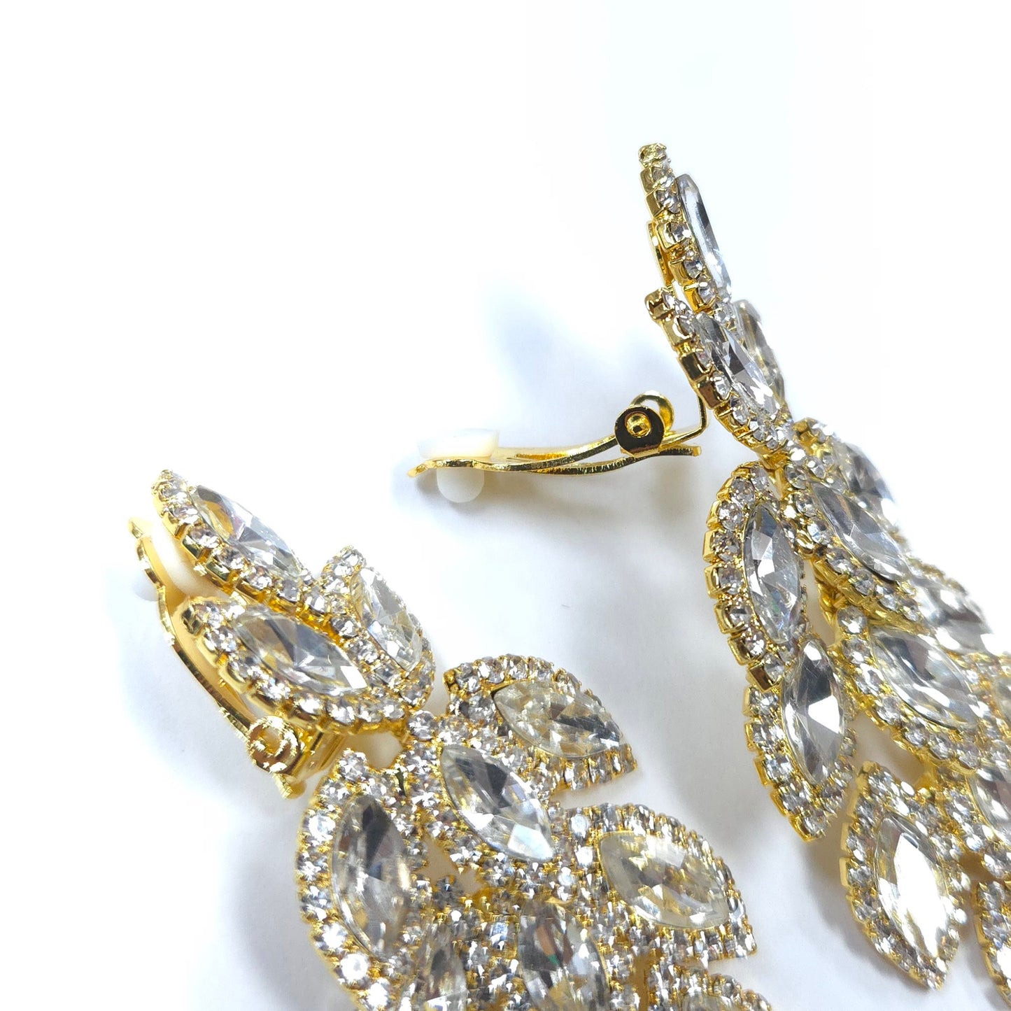 Gold and crystal earrings on a white background