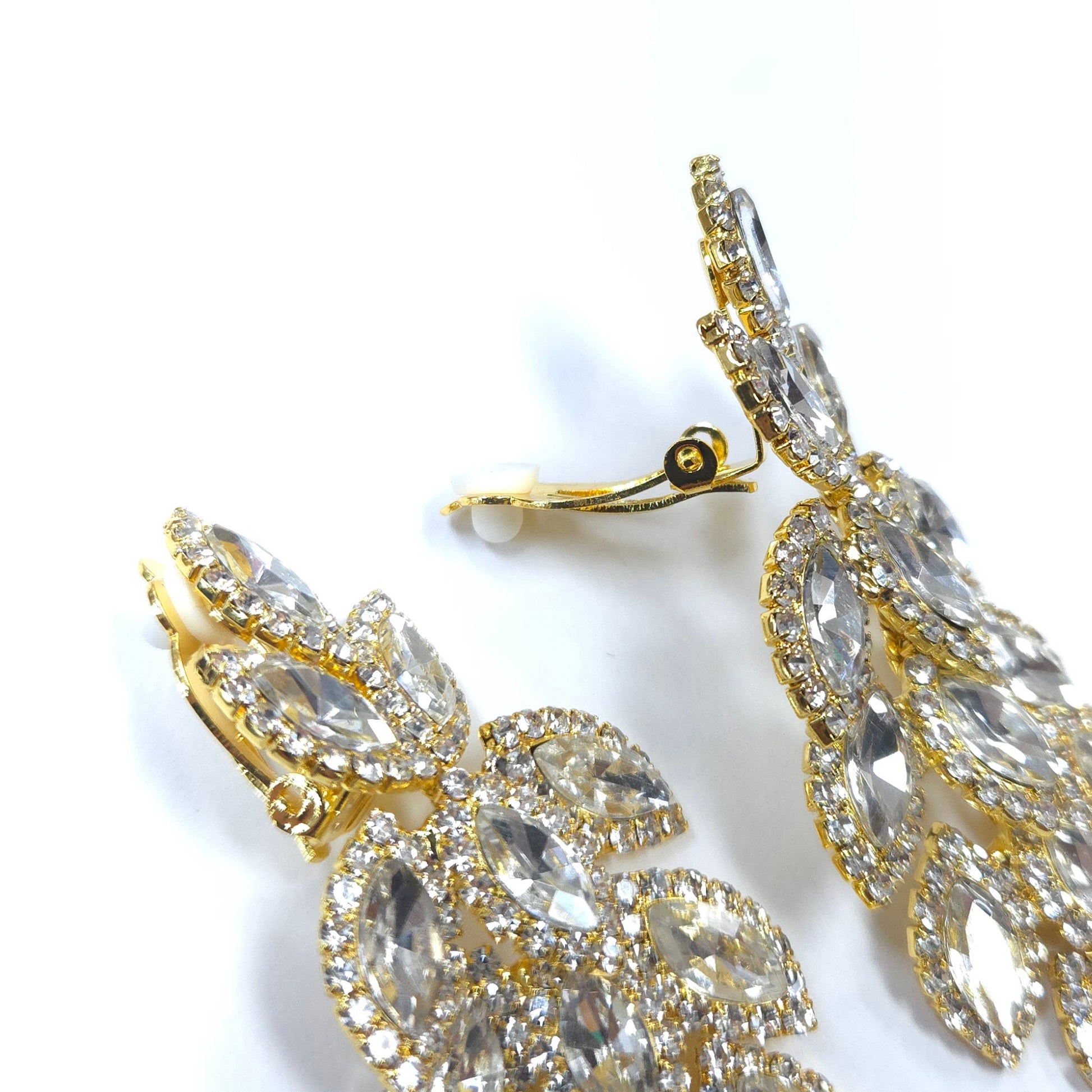 Gold and crystal earrings on a white background