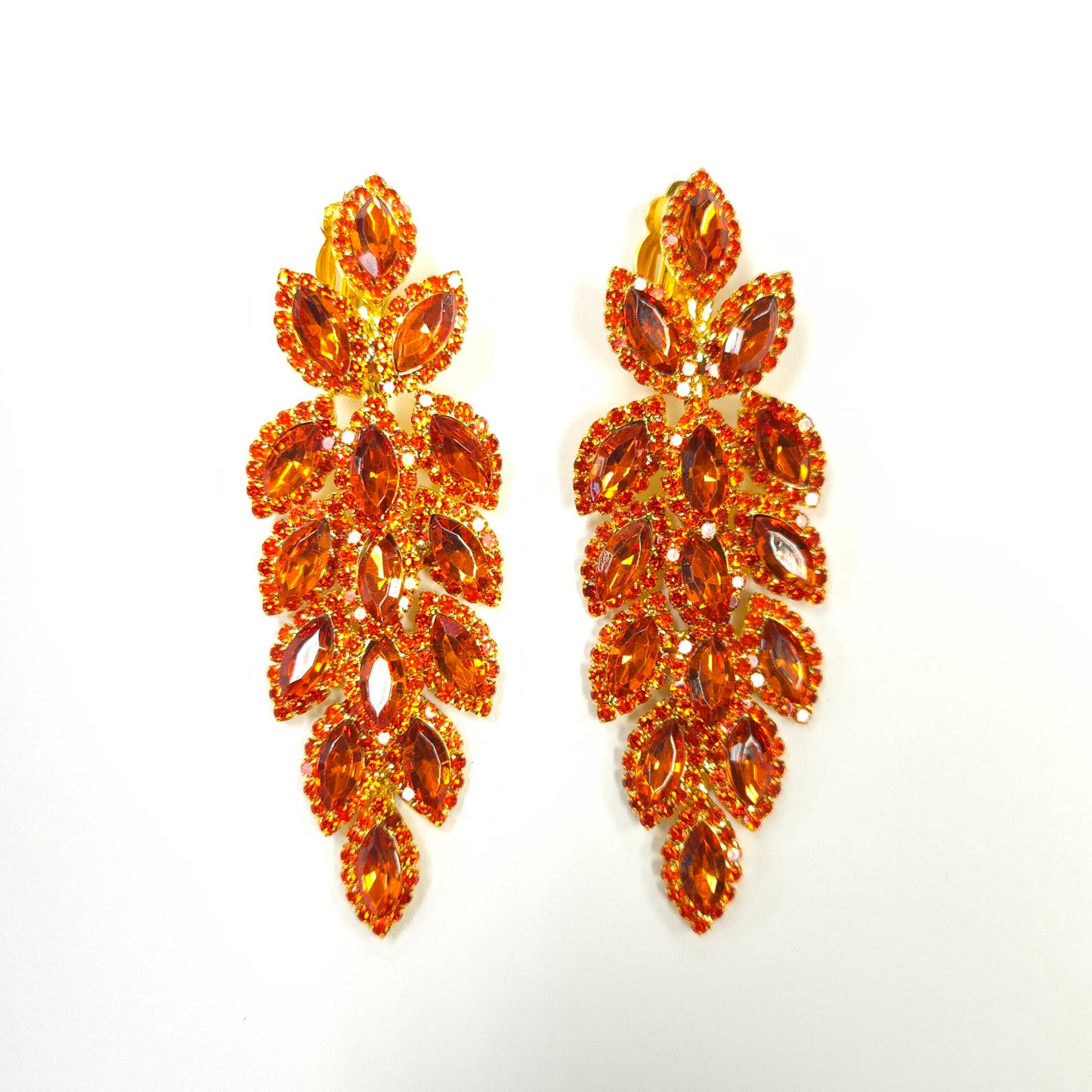 Pair of orange gemstone earrings on a white background