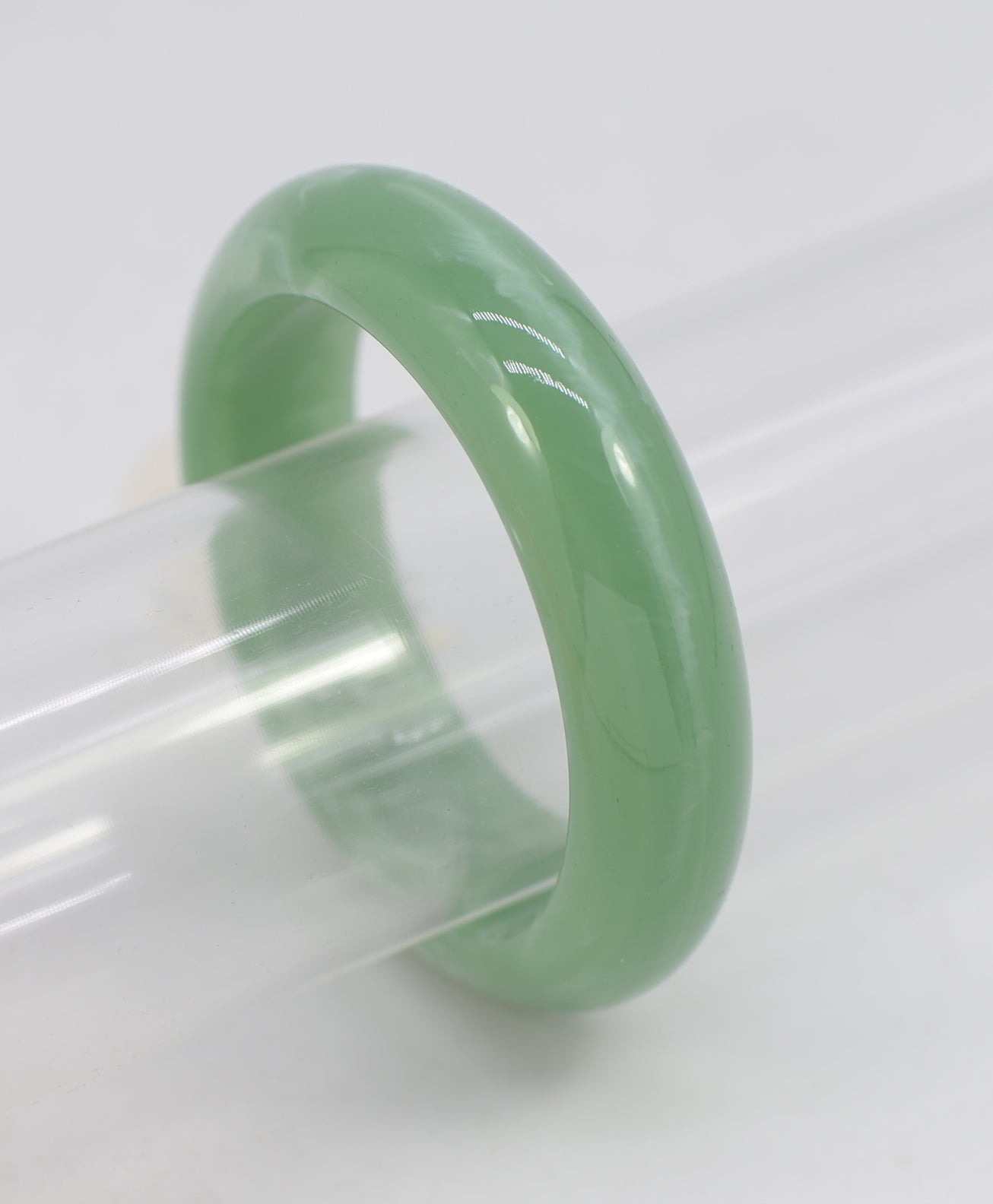 Green jade ring on a white background