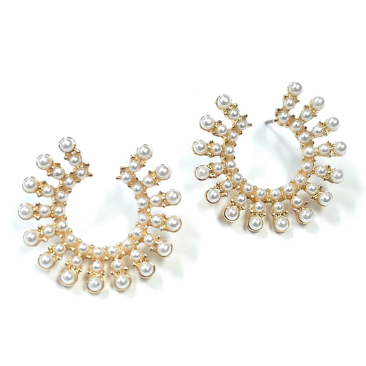 Pair of pearl earrings with gold accents on a white background