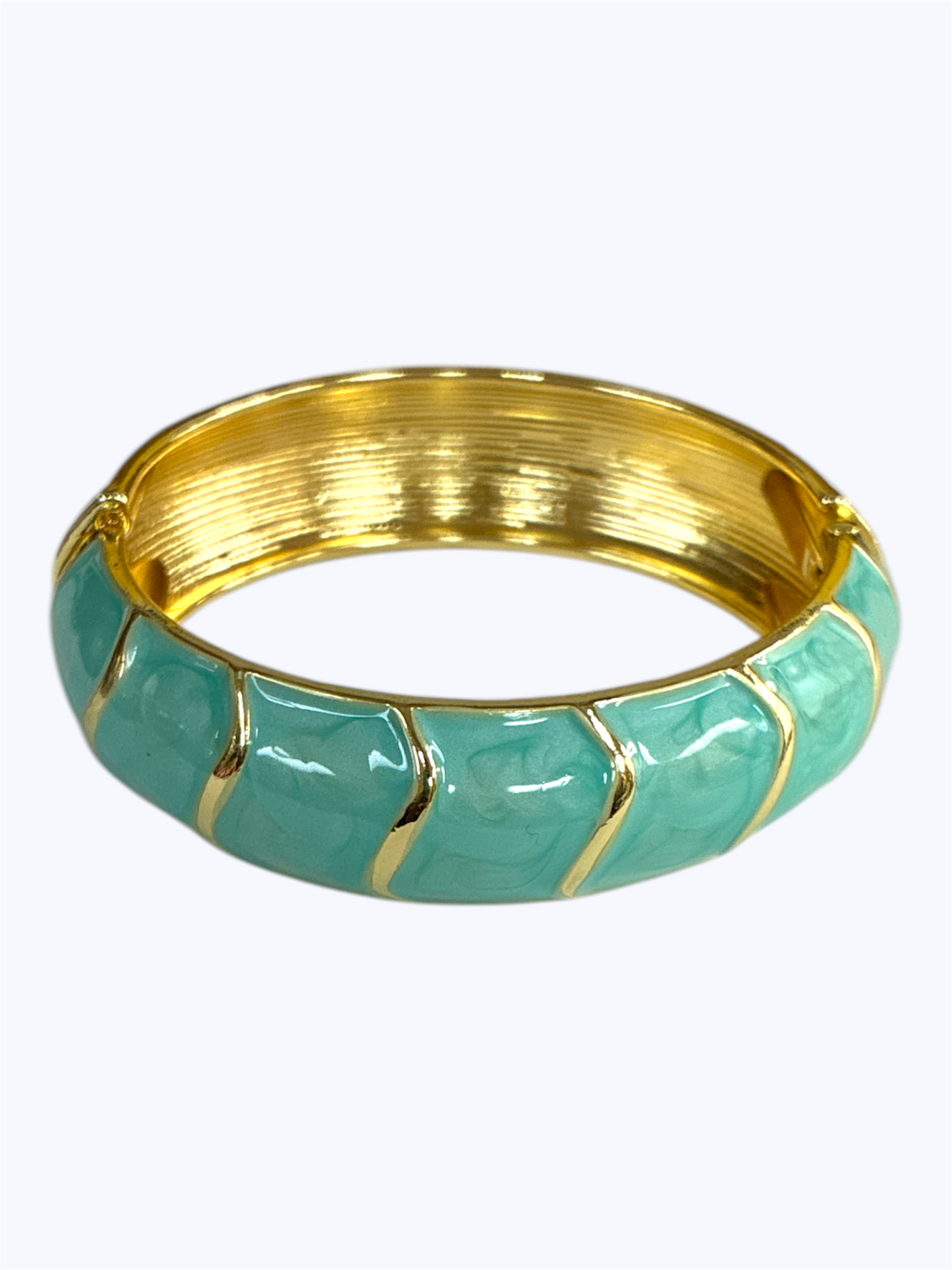 Gold and turquoise bangle on a white background