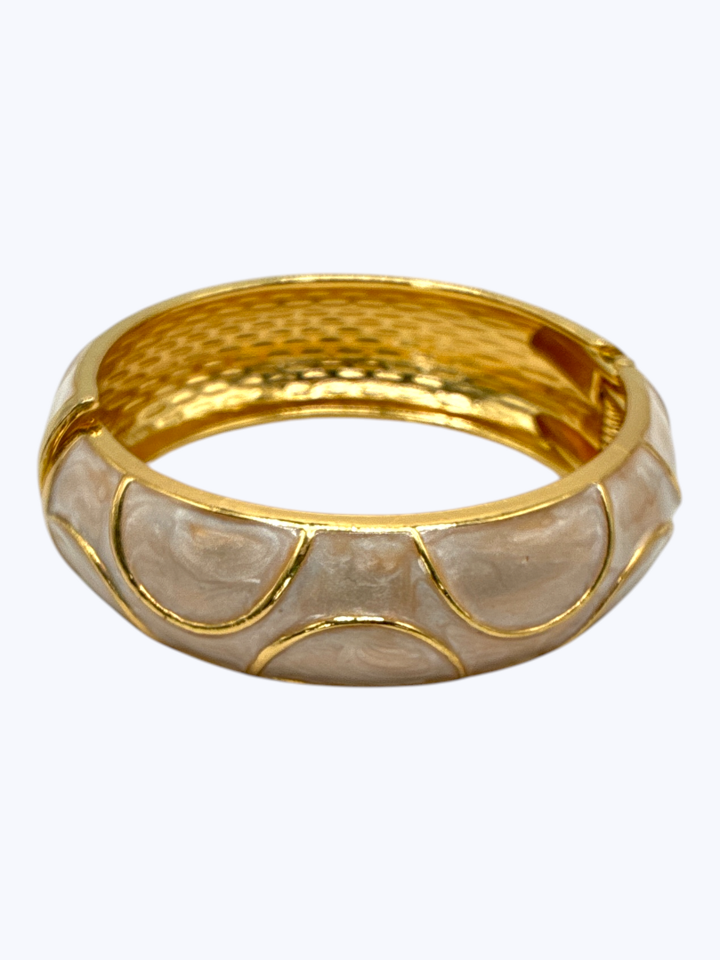 Gold-tone hinged bangle bracelet with glossy beige enamel accents and textured metallic finish for an elegant boutique-inspired look.