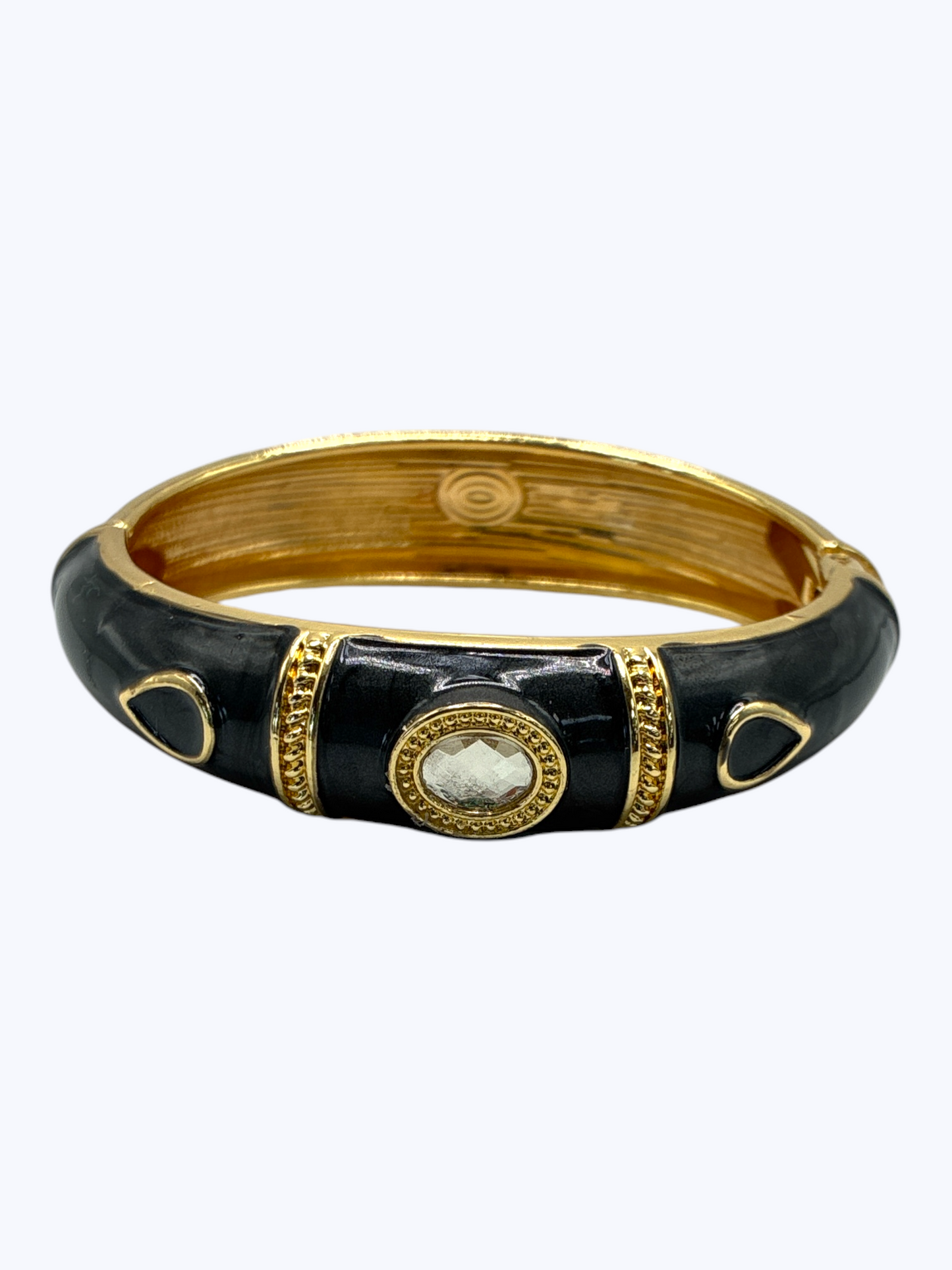 Black and gold bracelet on a white background