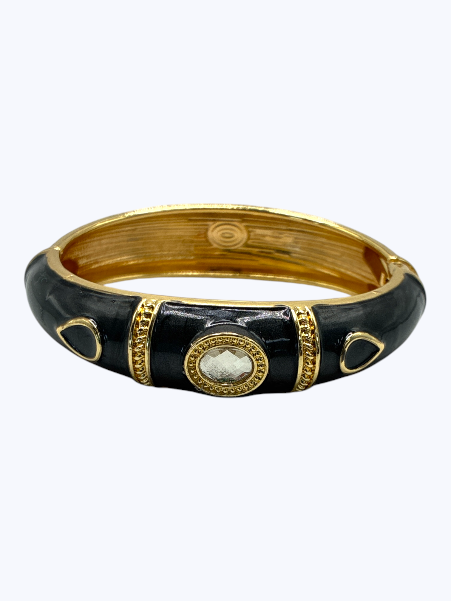 Black and gold bracelet on a white background