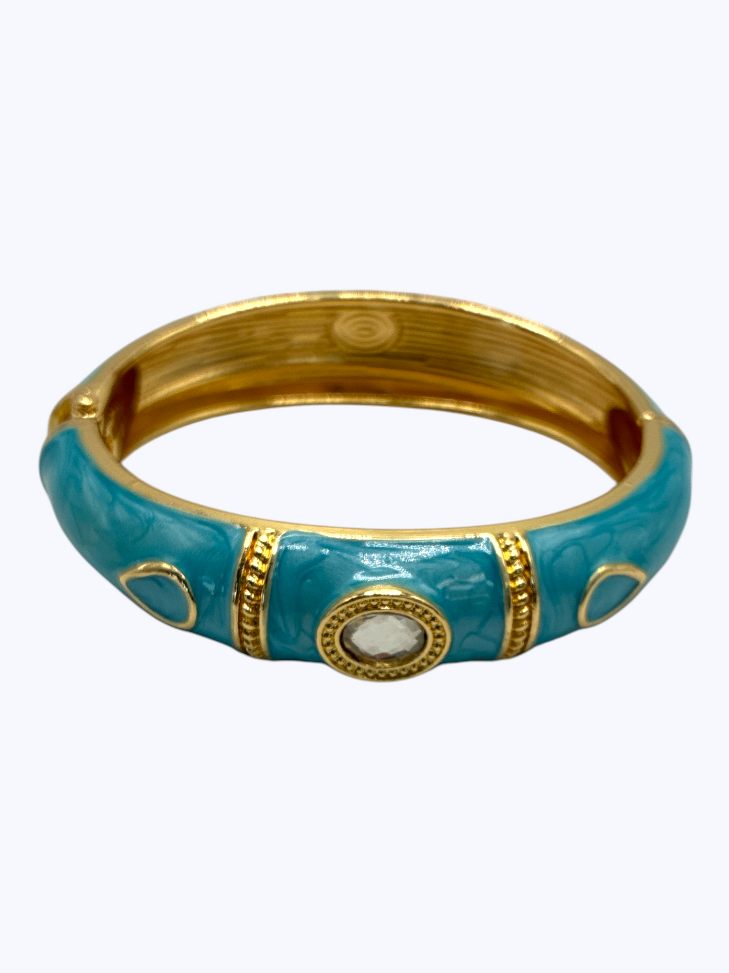 Turquoise bangle with gold accents on a white background