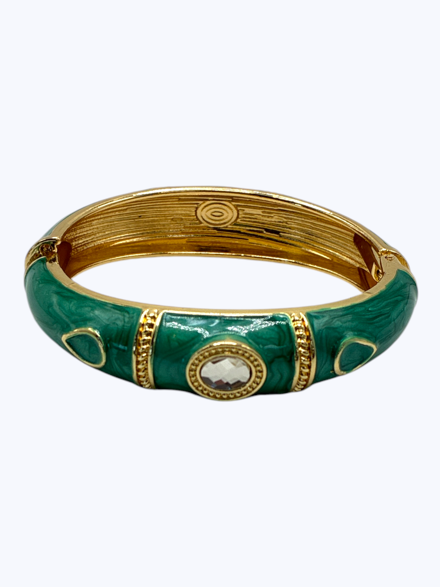 Gold and green bracelet with decorative elements on a white background