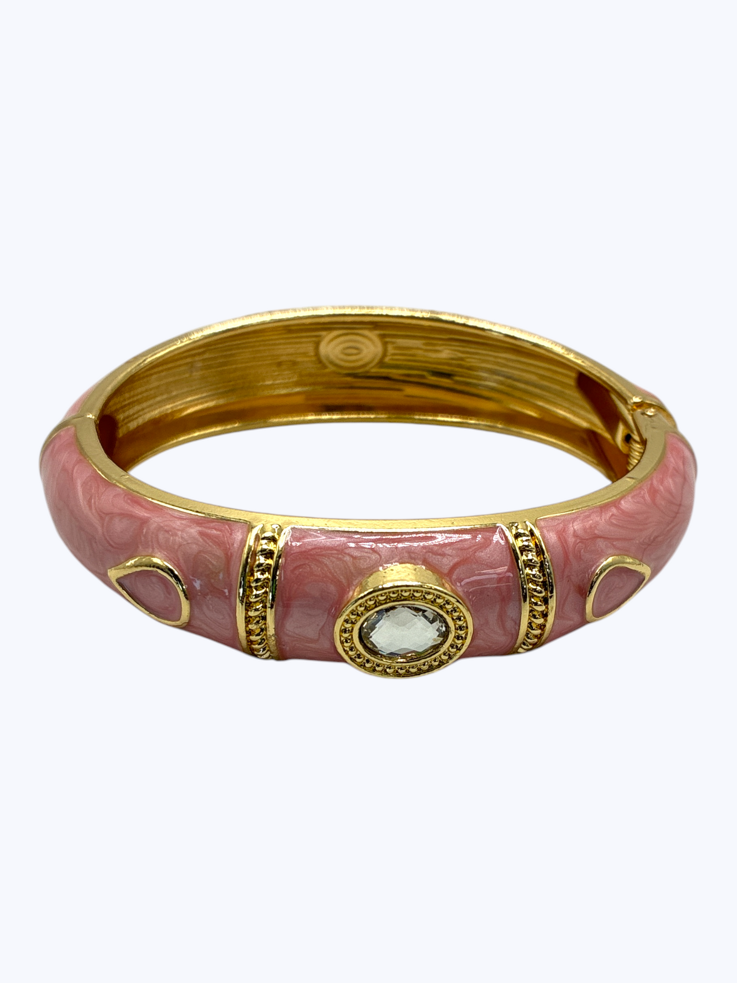 Pink bangle with gold accents on a white background