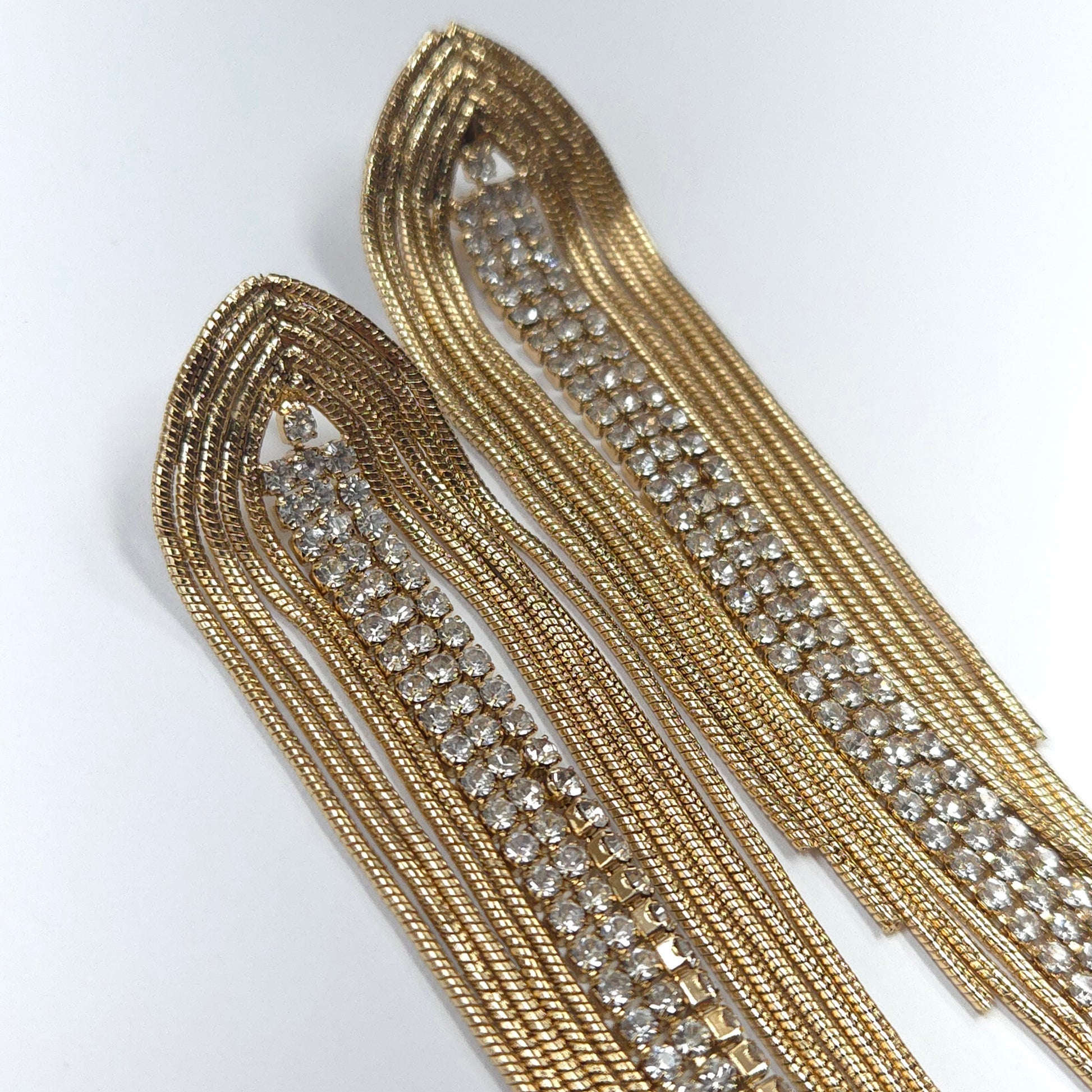 Gold trim with embedded crystals on a white background