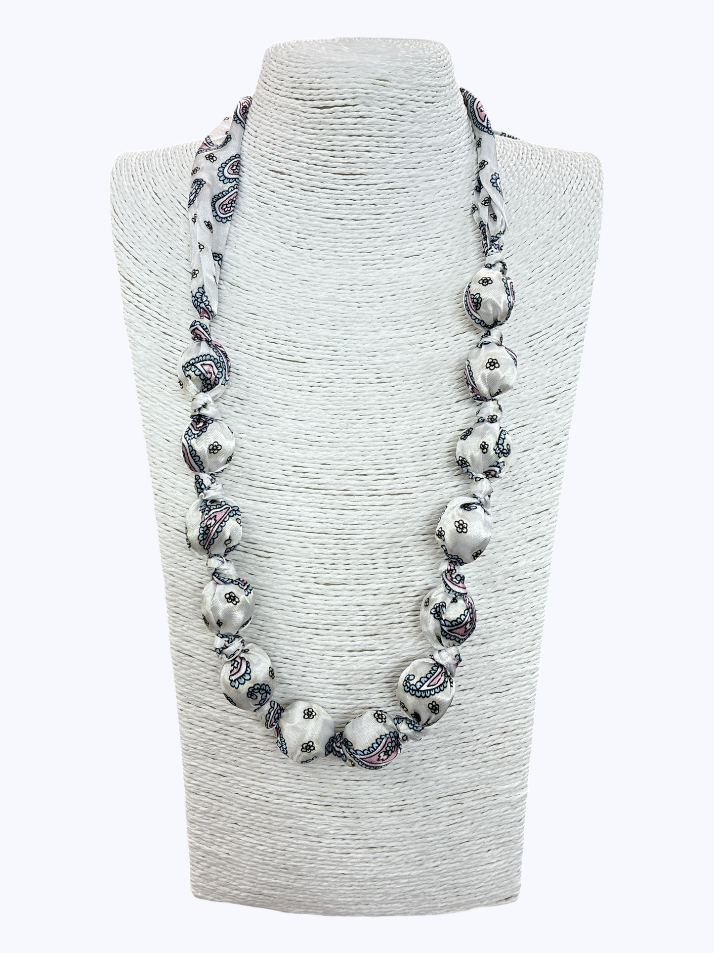 Necklace with decorative beads on a gray bust