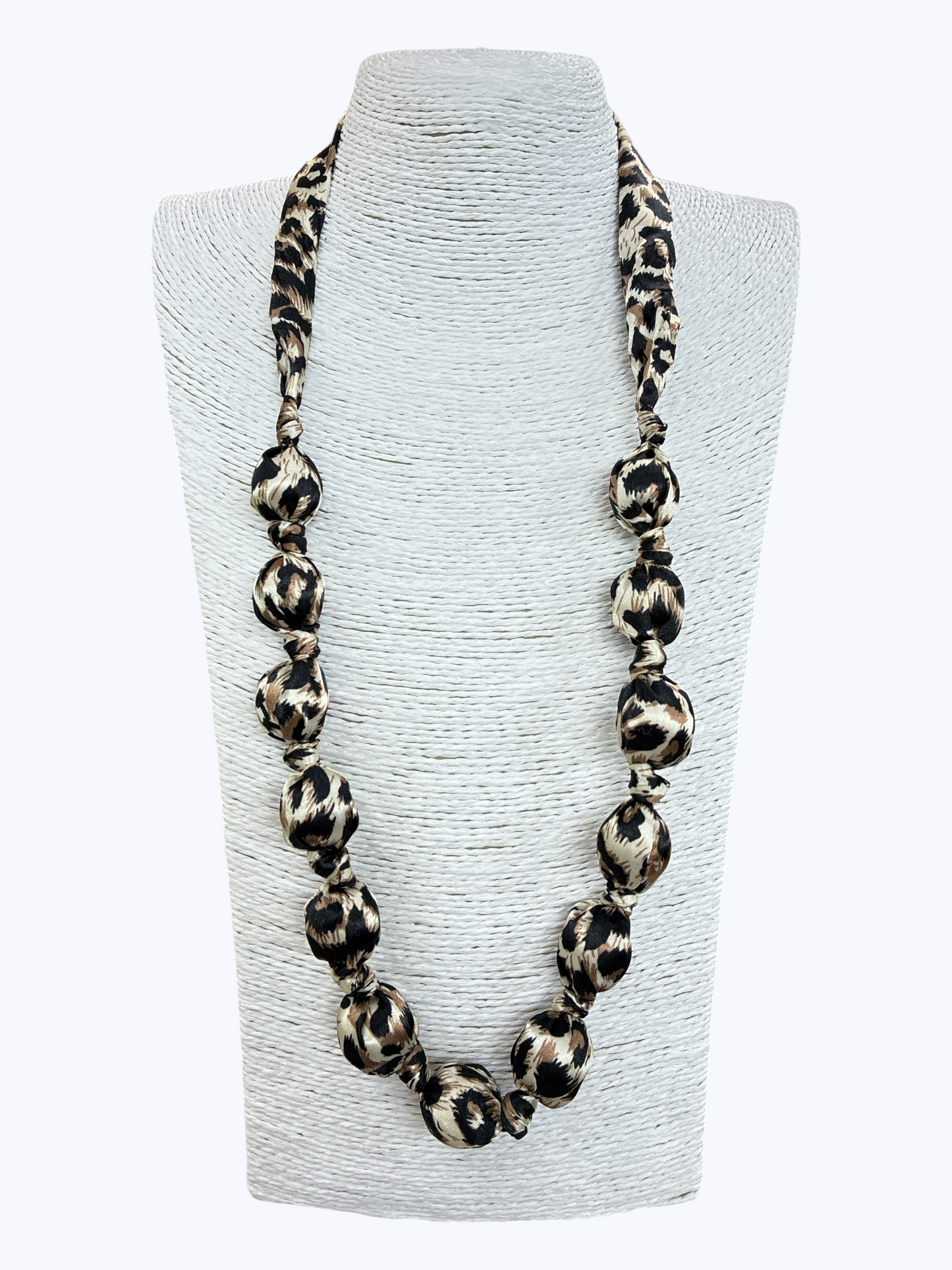 Leopard print necklace on a gray bust