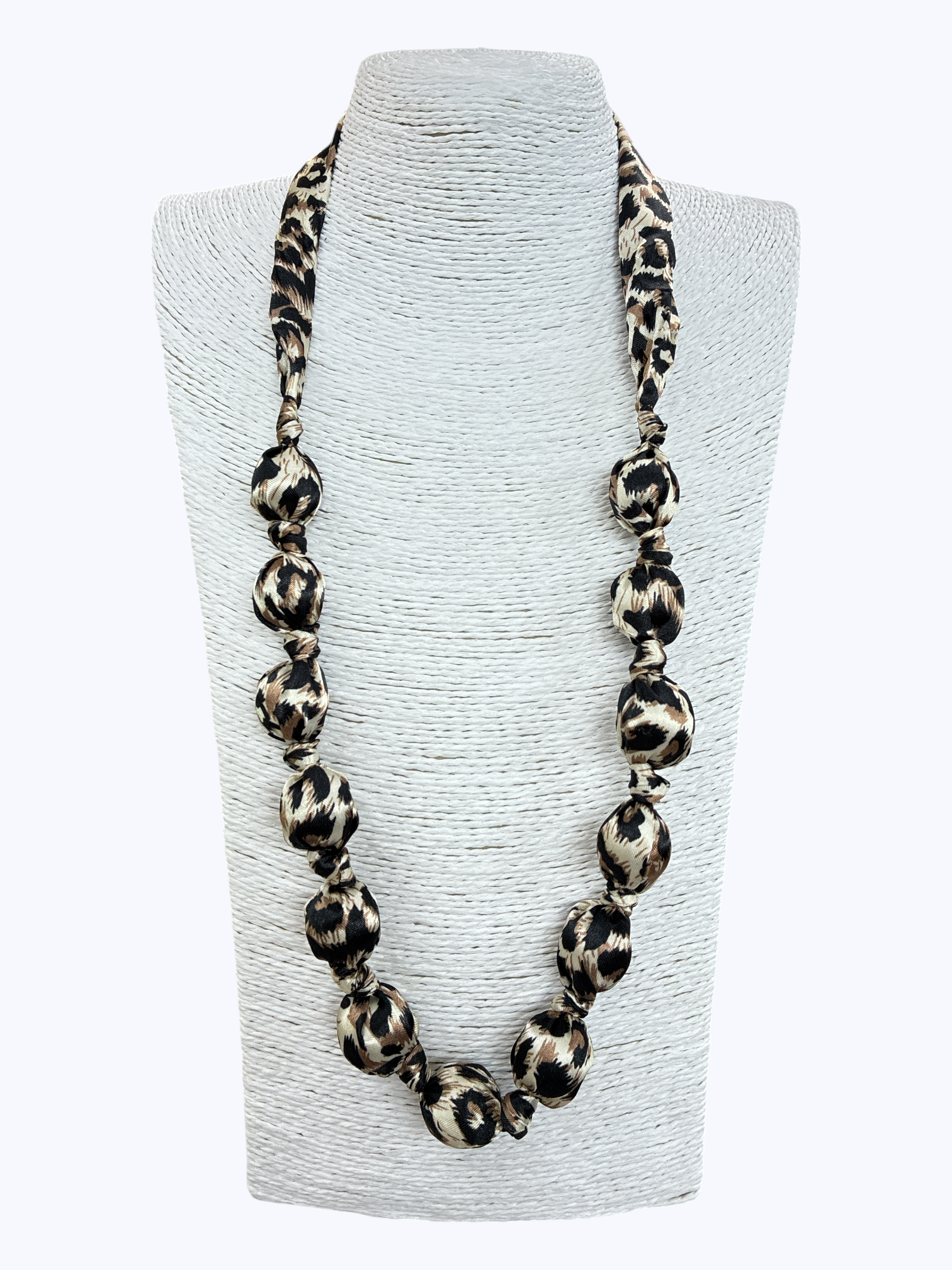 Leopard print necklace on a gray bust