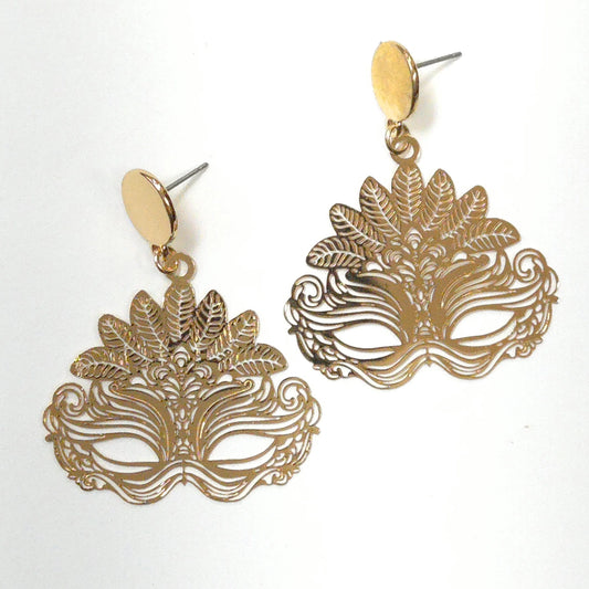 Gold mask-shaped earrings on a white background