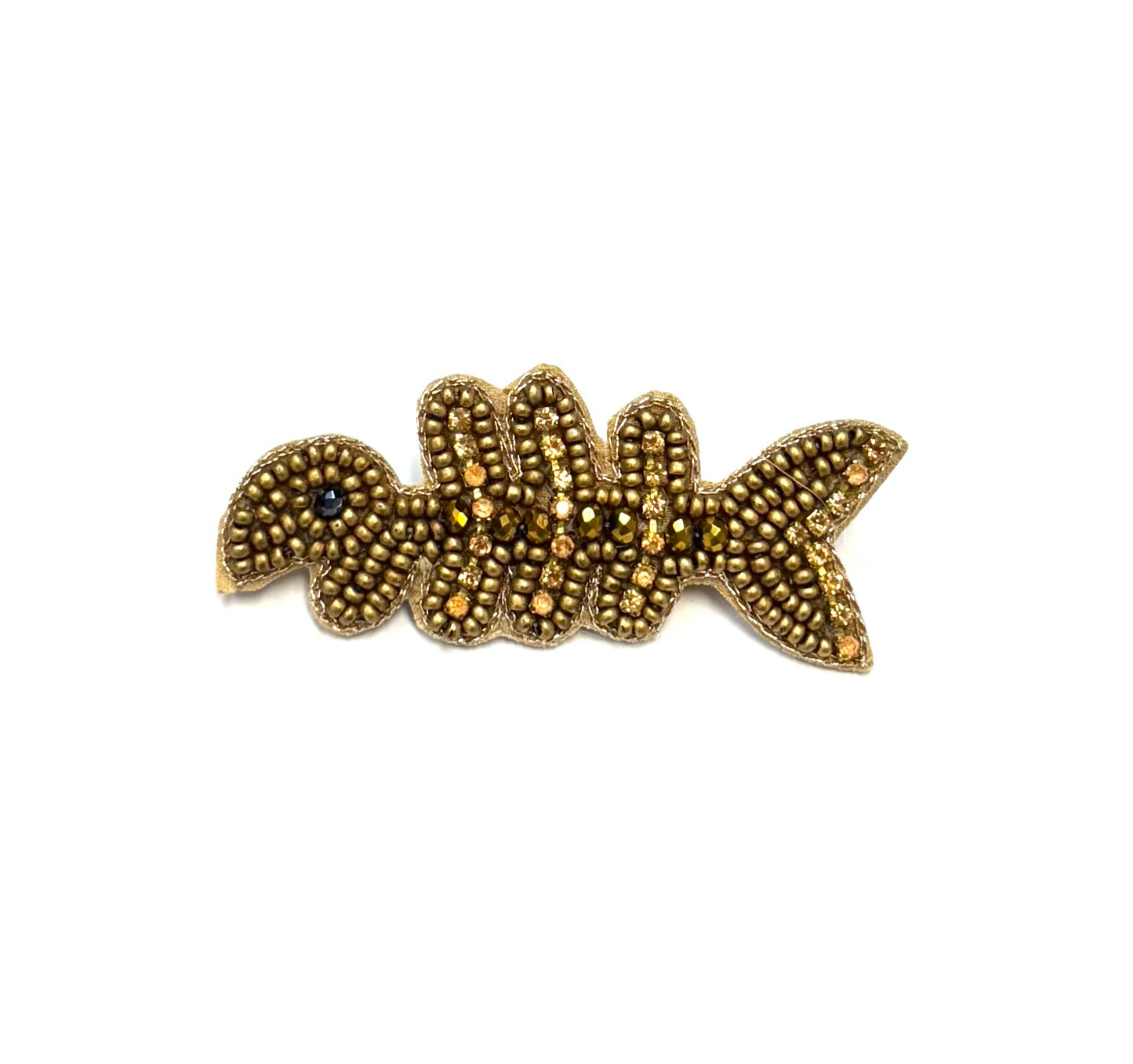 Gold fish-shaped brooch on a white background