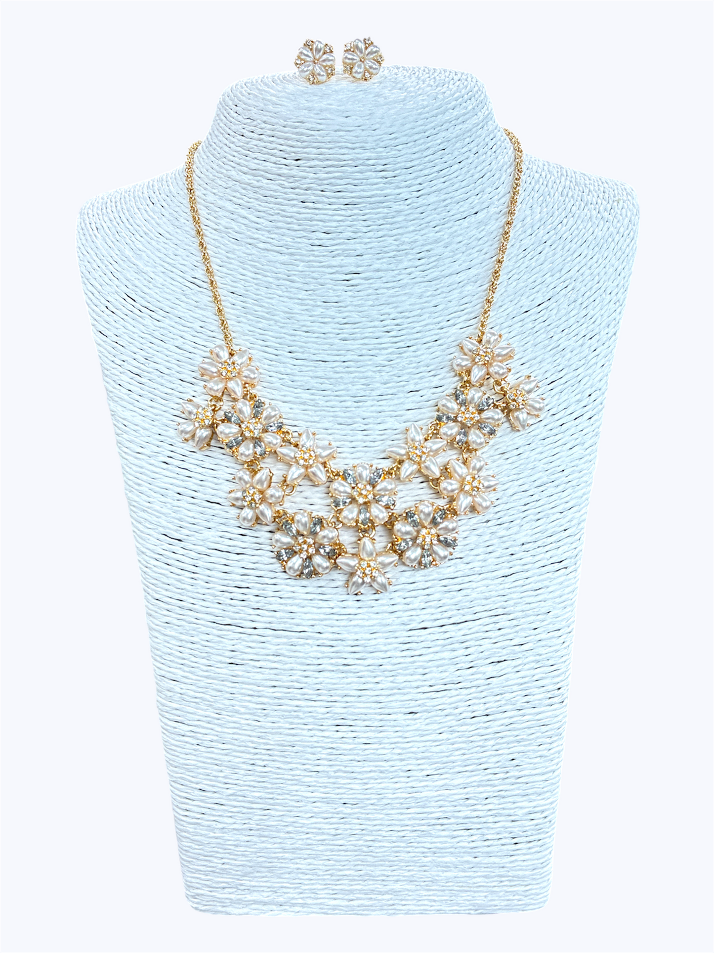 Elegant floral crystal bib necklace set with matching flower stud earrings featuring layered rhinestone petal clusters and gold-tone chain.