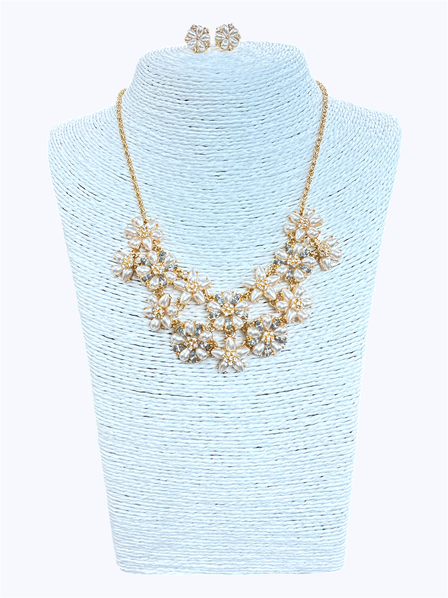 Elegant floral crystal bib necklace set with matching flower stud earrings featuring layered rhinestone petal clusters and gold-tone chain.