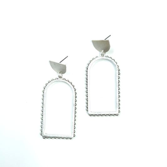 Pair of silver earrings with heart-shaped ends on a white background