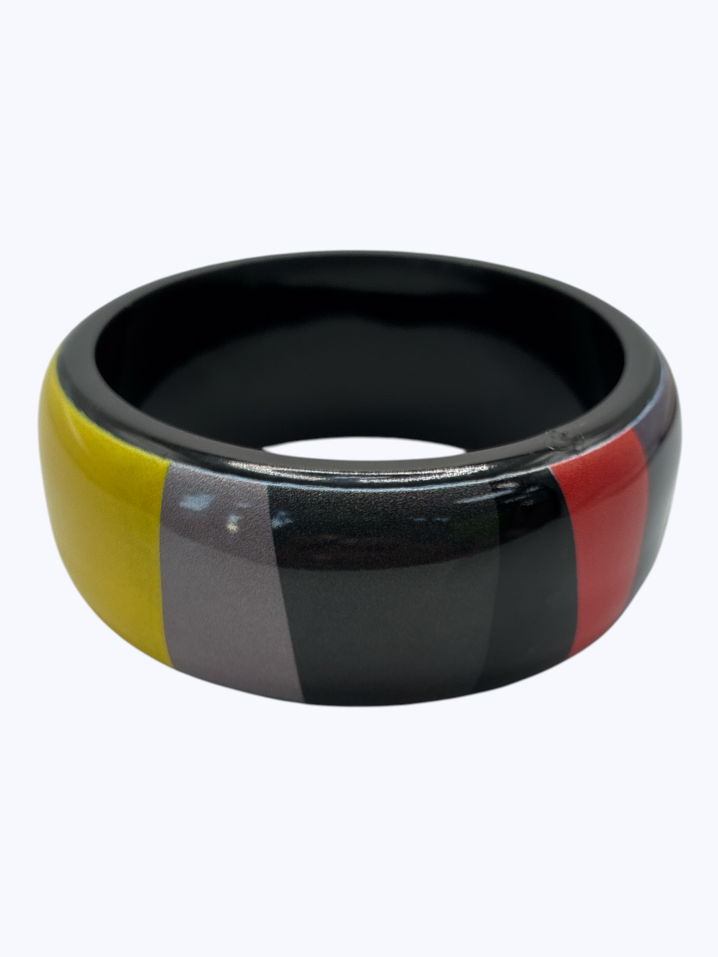 Colorful bracelet with black, yellow, gray, and red sections on a white background