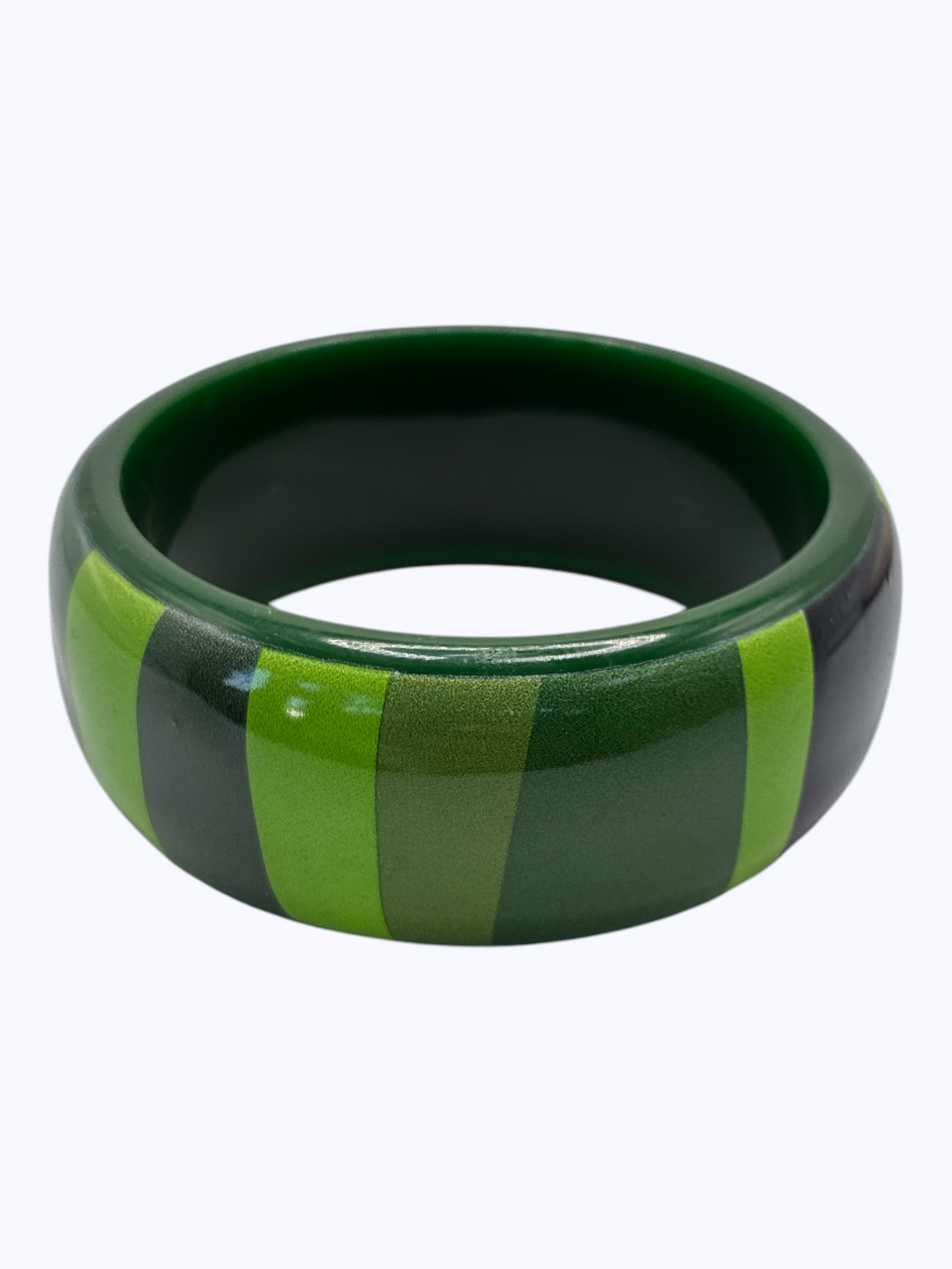 Green and black striped bangle on a white background