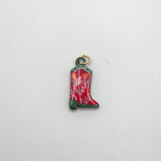 Red cowboy boot charm on a white background