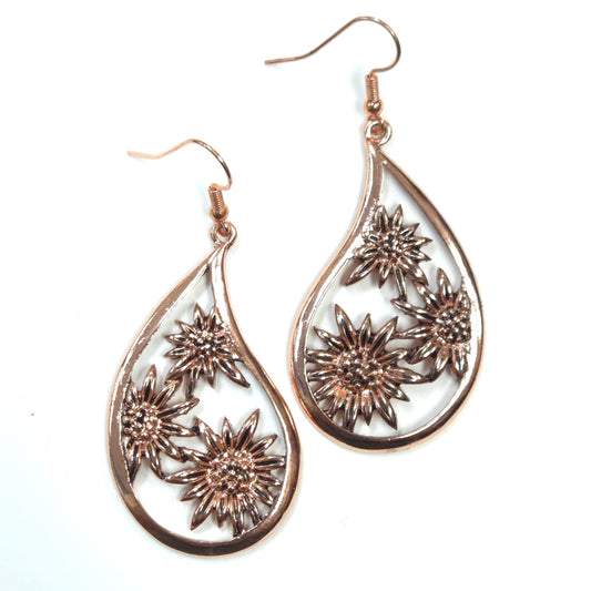 Teardrop-shaped earrings with floral designs on a white background
