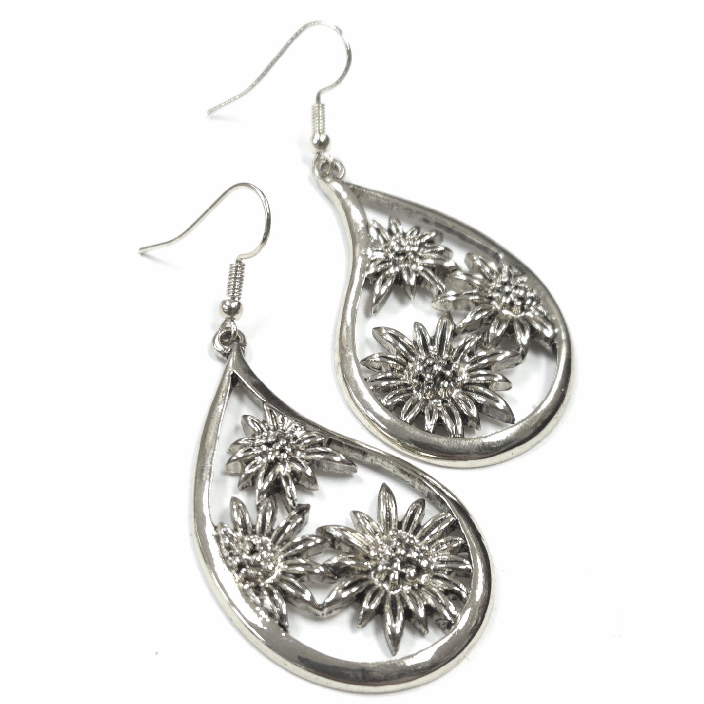 Silver teardrop earrings with floral designs on a white background
