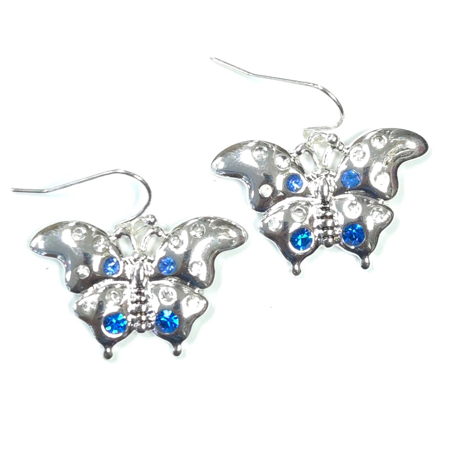 Butterfly-shaped earrings with blue gemstones on a white background