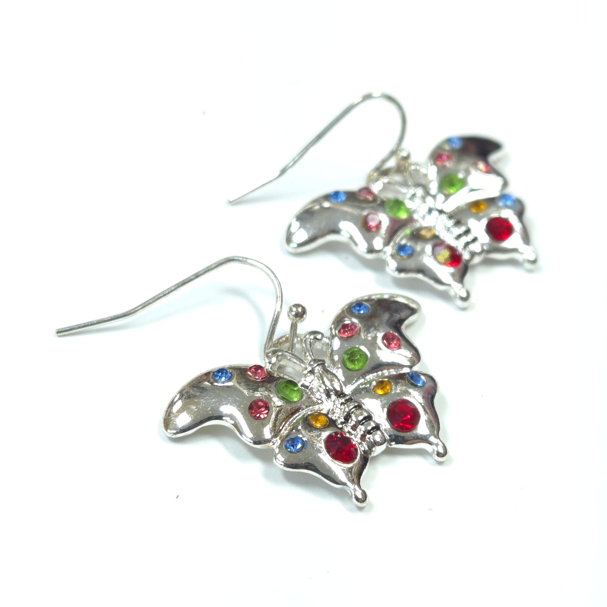 Butterfly-shaped earrings with colorful gemstones on a white background