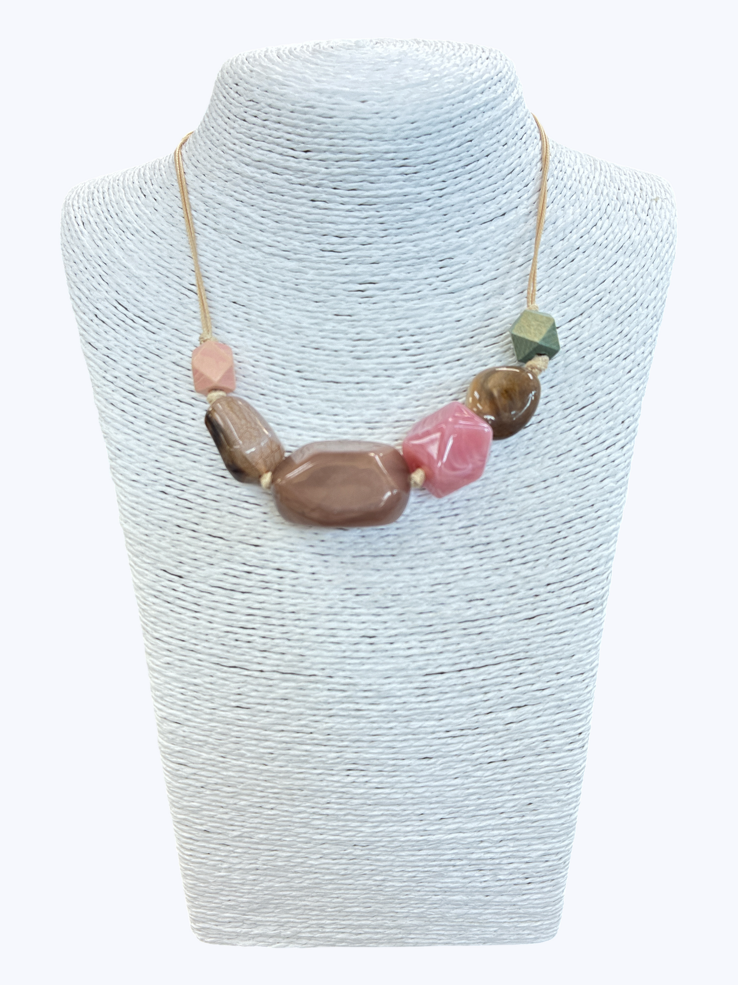 Neutral pink and taupe statement bead necklace with glossy marbled resin accents for a soft contemporary boutique look.