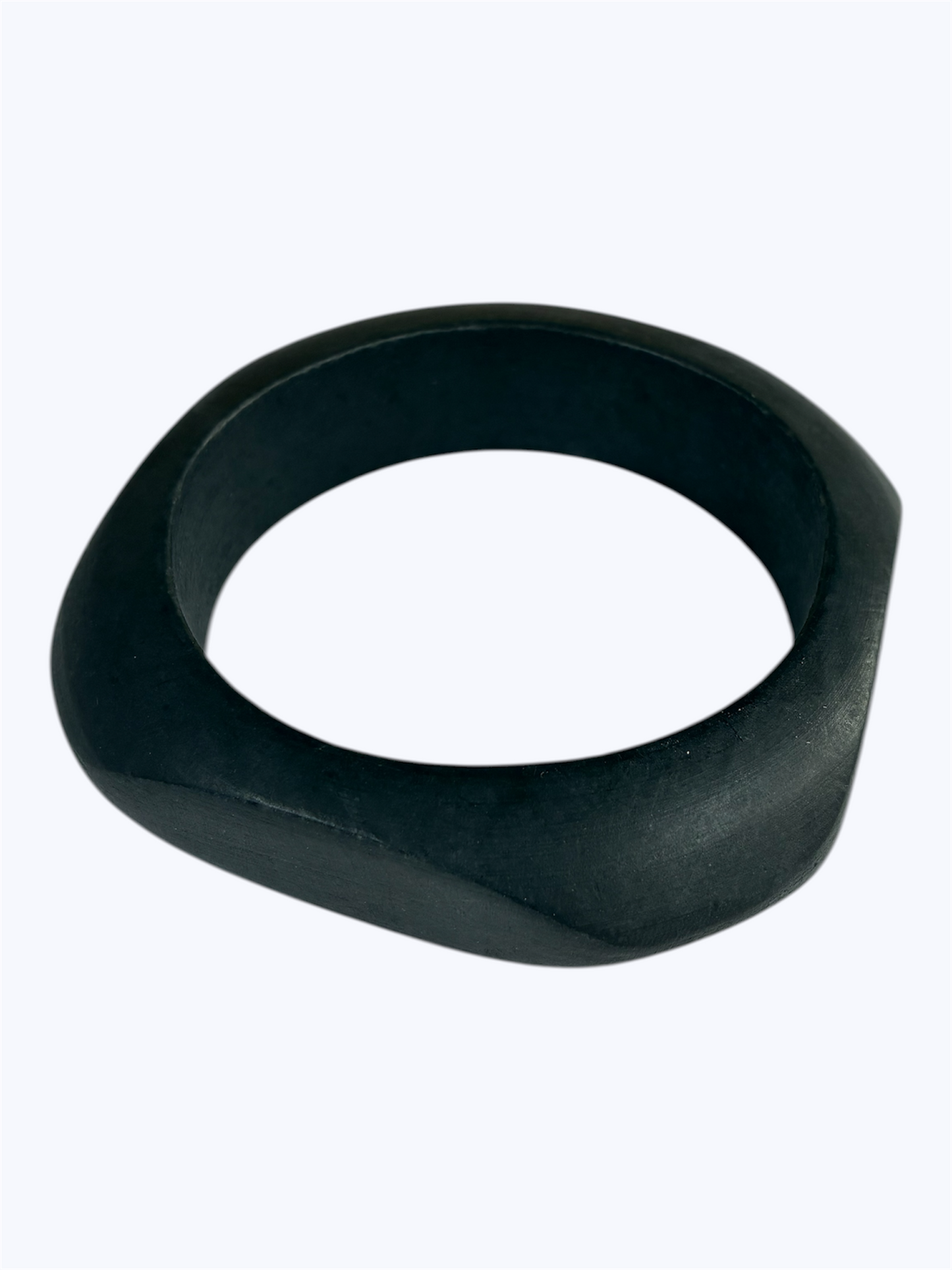 Matte black sculpted bangle bracelet with an organic asymmetrical silhouette and minimalist modern design