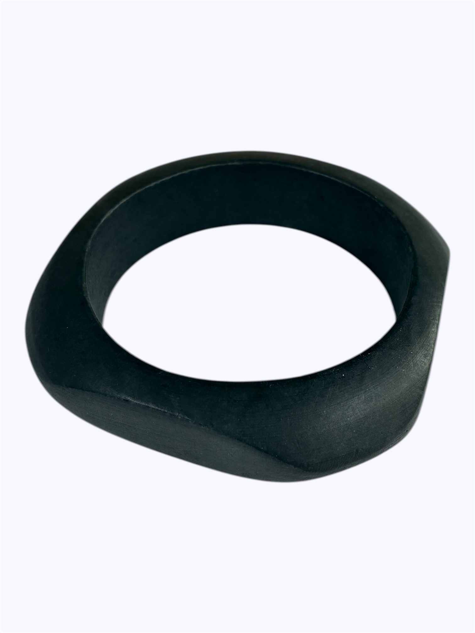 Matte black sculpted bangle bracelet with an organic asymmetrical silhouette and minimalist modern design