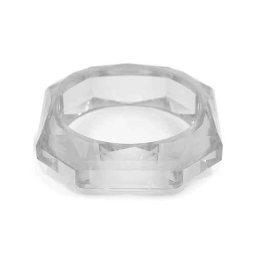 Bold geometric faceted acrylic bracelet featuring transparent sculptural bangle design with polished contemporary finish.