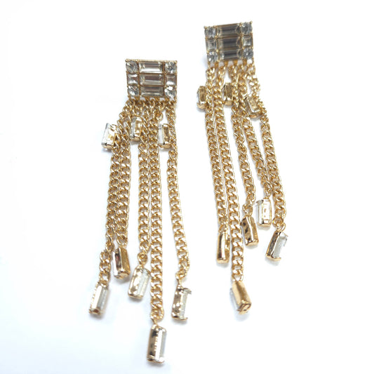Gold chain earrings with crystal-like stones on a white background