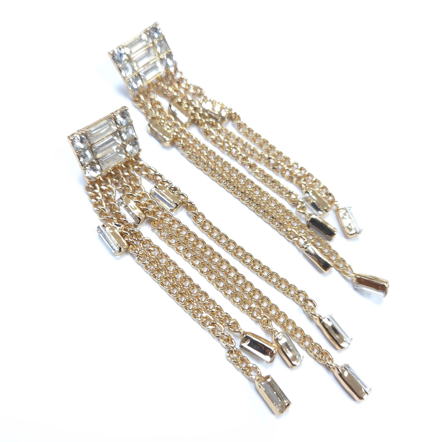 Gold chain earrings with clear gemstones on a white background