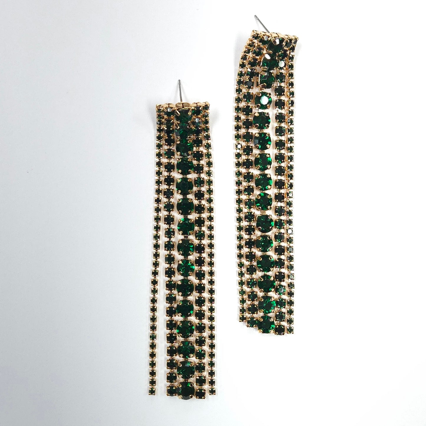 Long earrings with green and gold stones on a white background