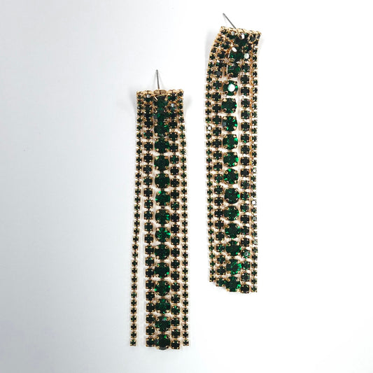 Long earrings with green and gold stones on a white background