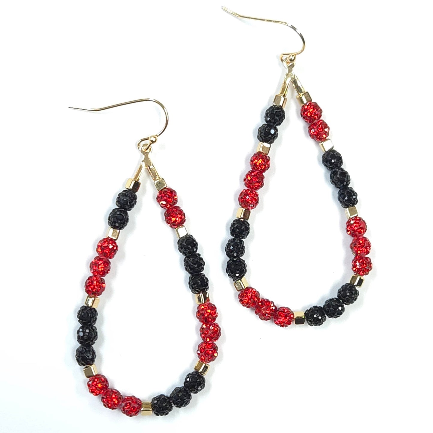Pair of hoop earrings with red and black beads on a white background