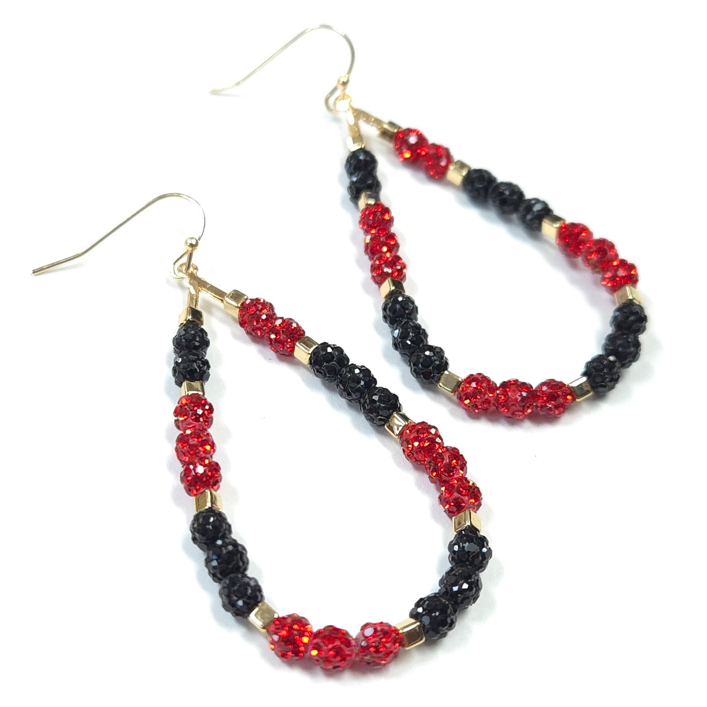 Pair of hoop earrings with red and black beads on a white background