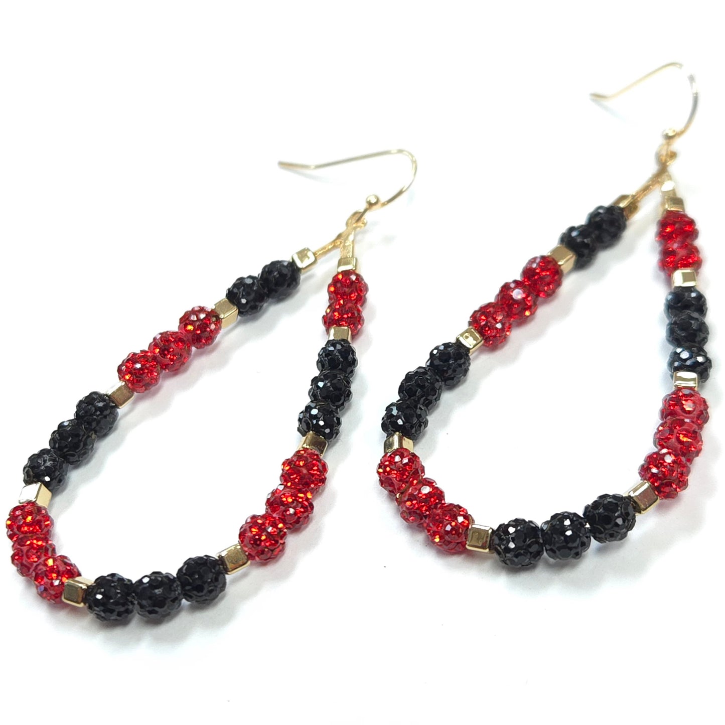Pair of hoop earrings with red and black beads on a white background