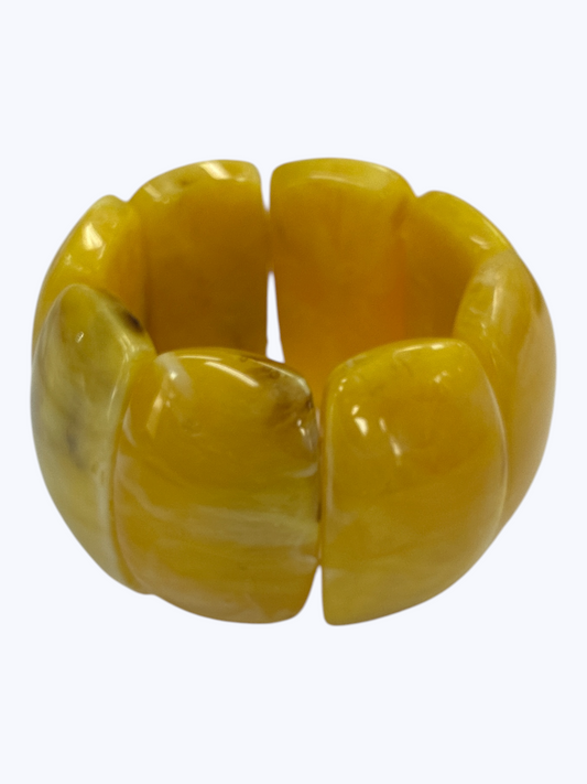 Chunky yellow marbled stretch bracelet with glossy oversized resin links for a vibrant contemporary boutique look.