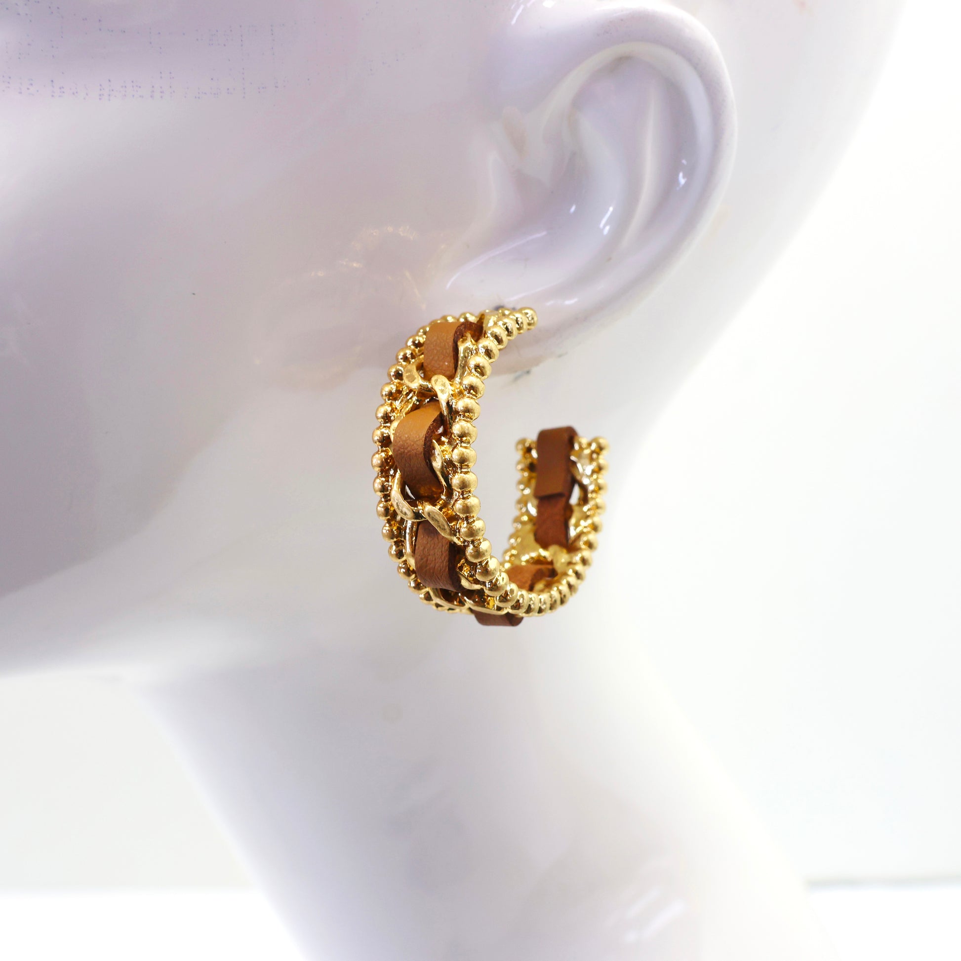 Braided chain hoop earrings with textured beaded edging and woven detail in a modern boutique fashion style.