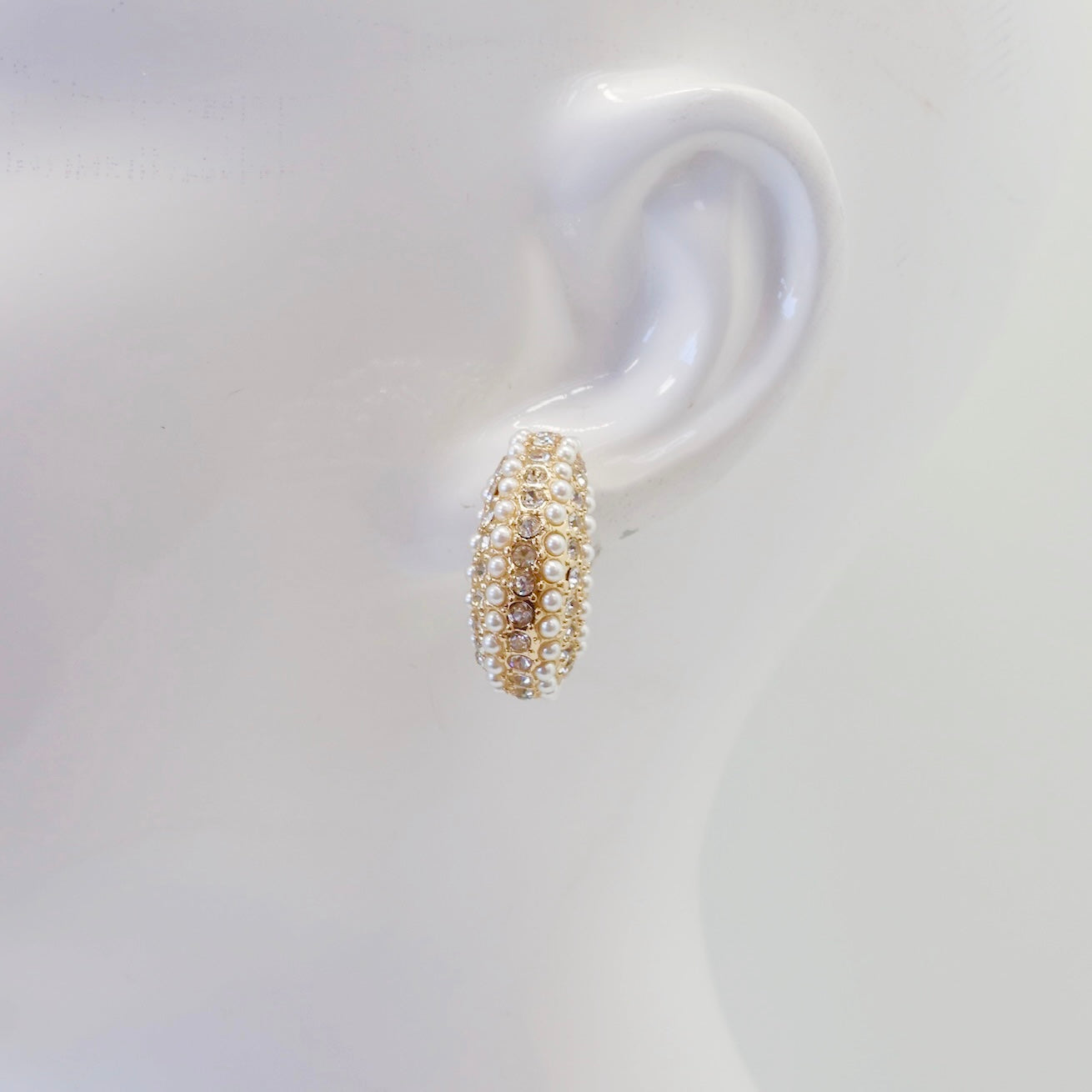 Open hoop earrings with crystal pave detailing and pearl accents in a glamorous boutique fashion style.