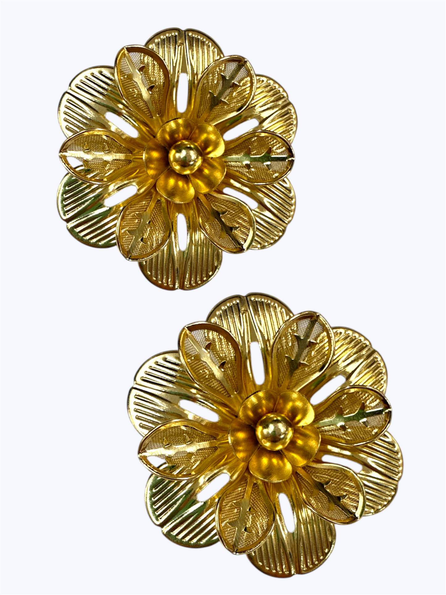 Layered floral stud earrings with textured petals and ornate filigree flower detailing.