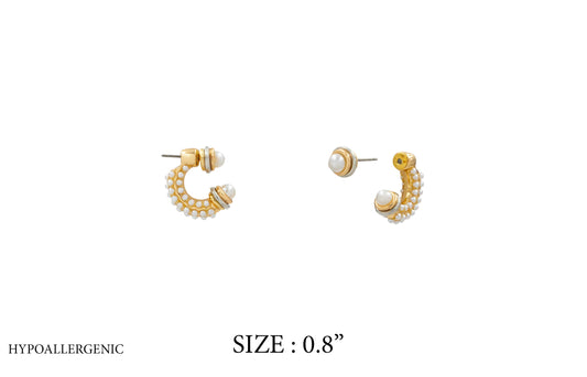 Gold hoop earrings with pearls on a white background